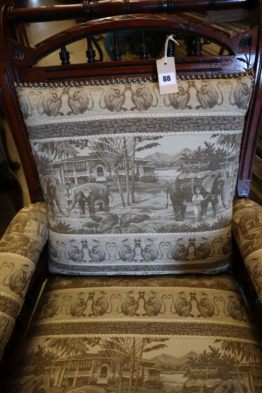 A Victorian aesthetic movement inlaid mahogany armchair, with later elephant pattern upholstery, width 68cm height 93cm